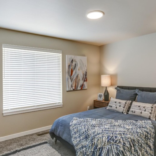 a bedroom with a bed and lamps