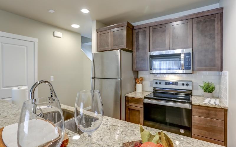 a kitchen with a glass of wine